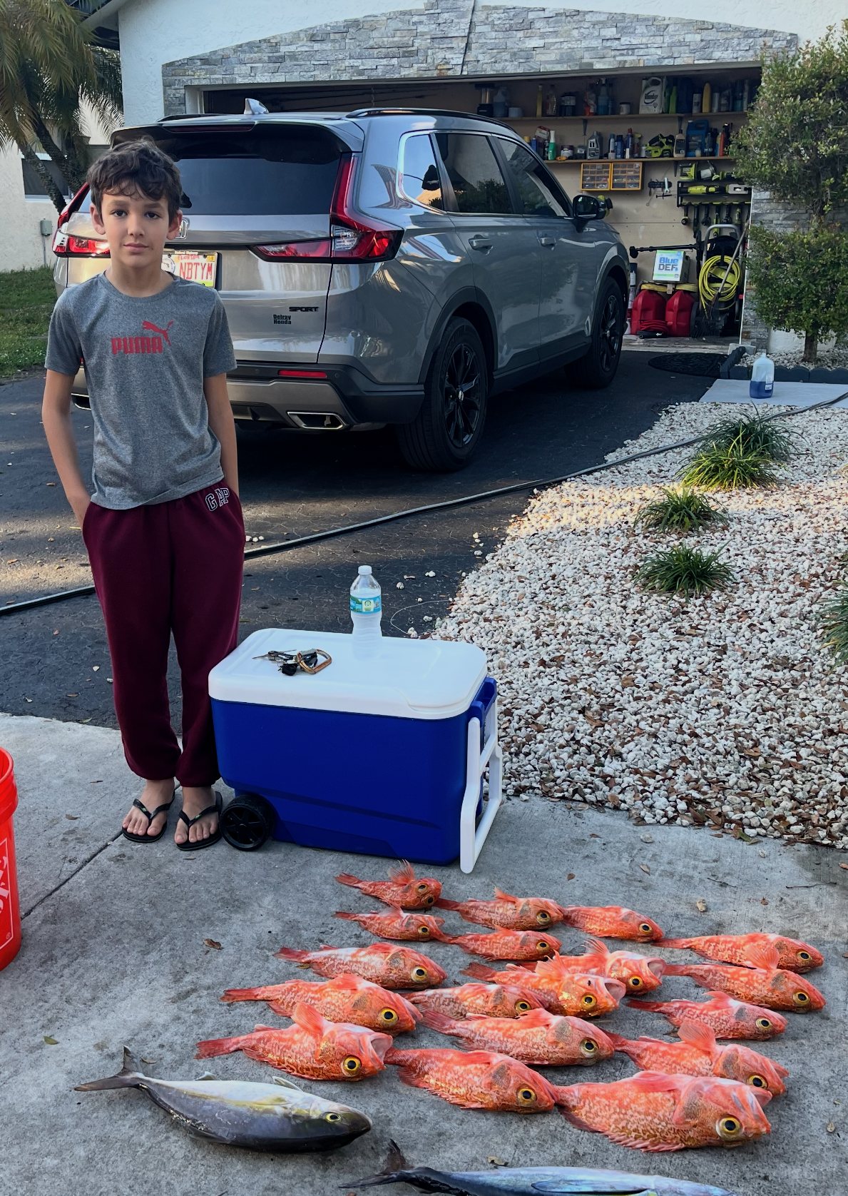 Young angler beside the day’s catch
