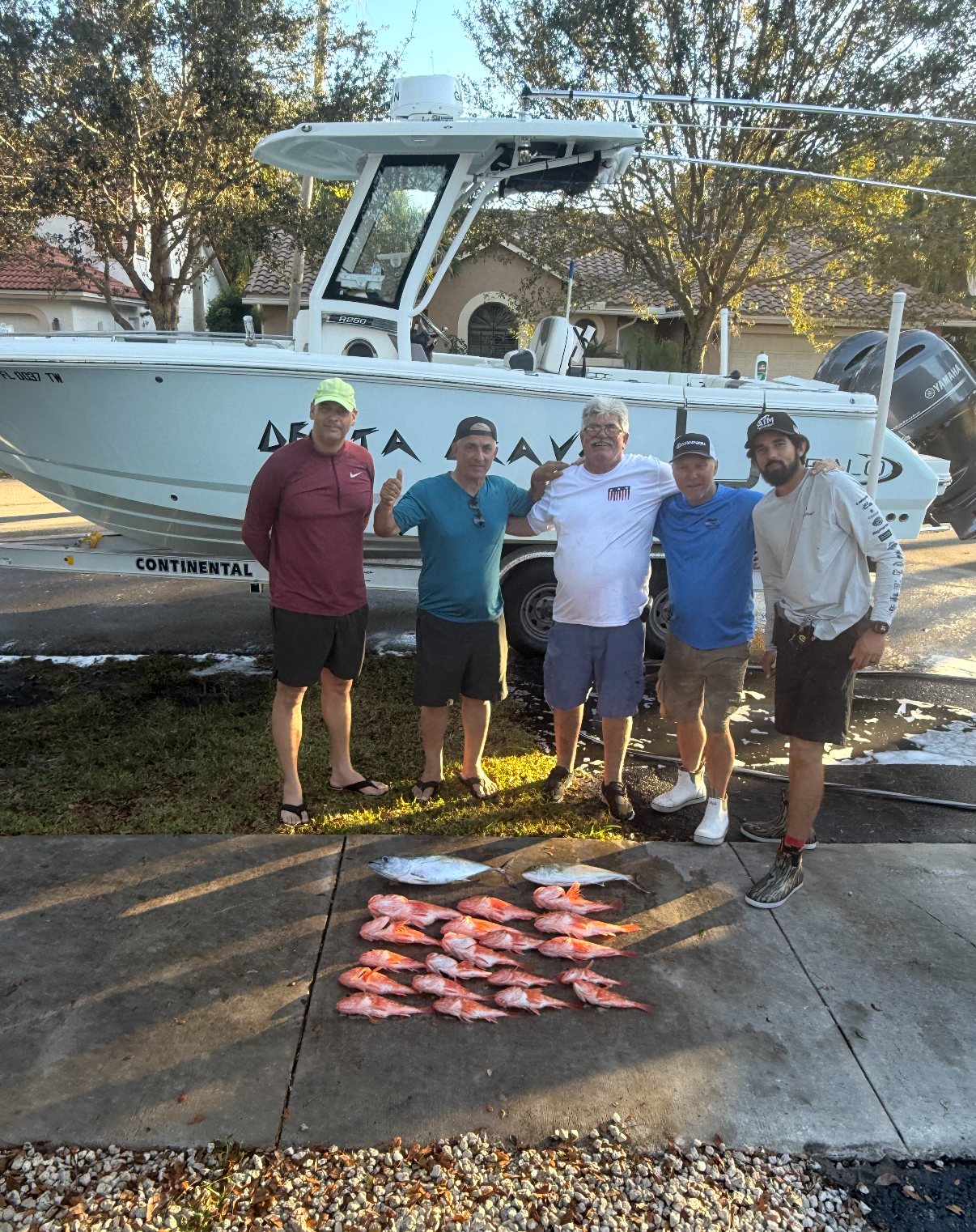 Group beside the Robalo boat with their catches