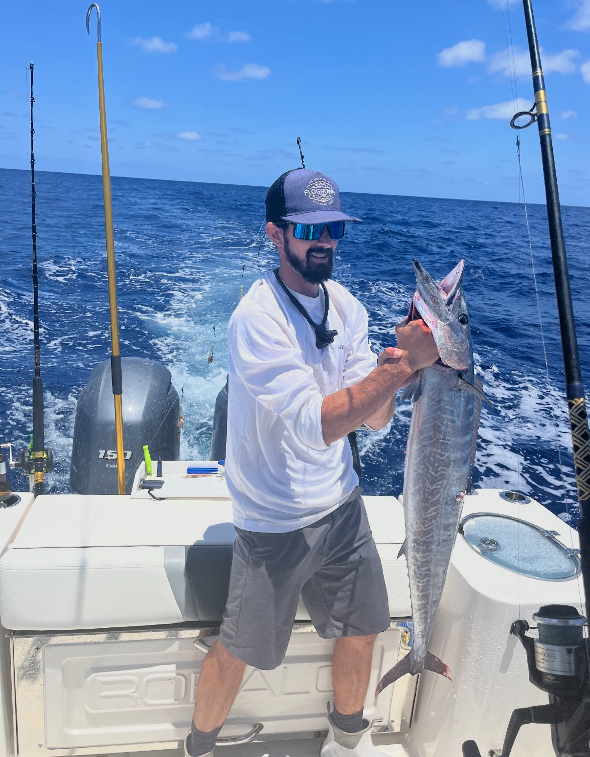 Angler holding a catch aboard Delta Bravo
